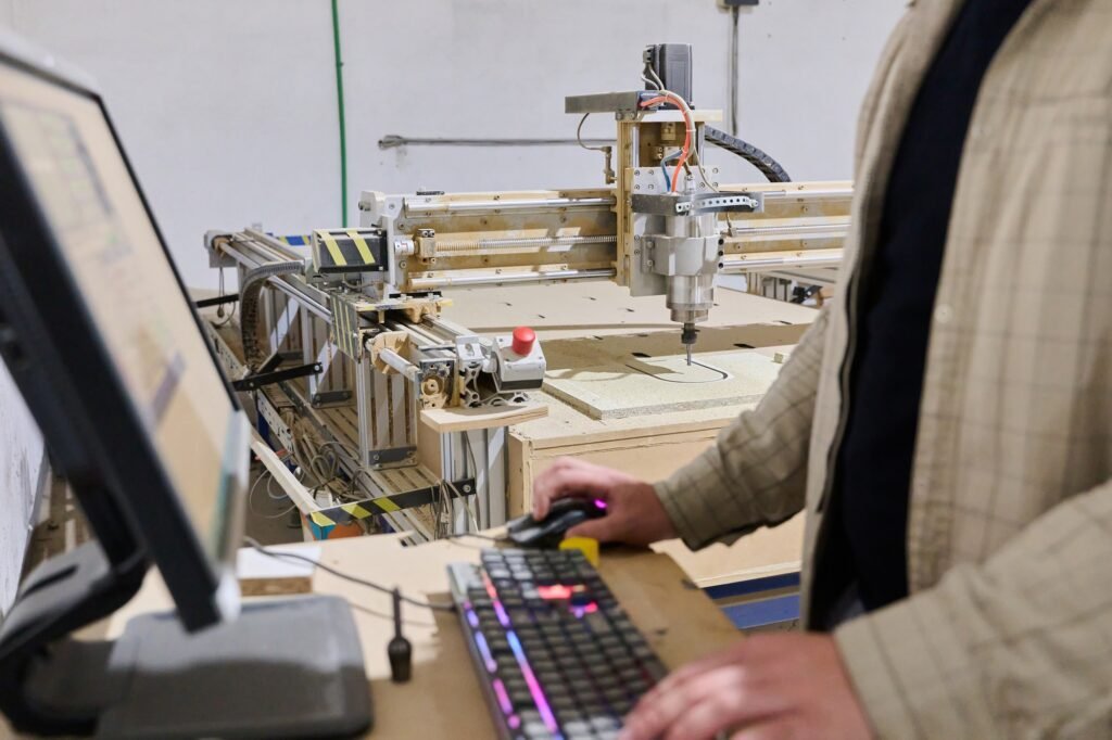 Operator Entering Coordinates on Computer for CNC Machine to Precisely Cut Wooden Pieces