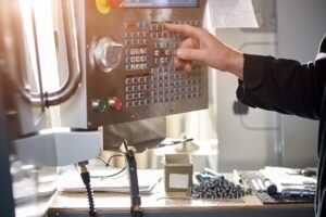 Cnc machine controls, male hand.