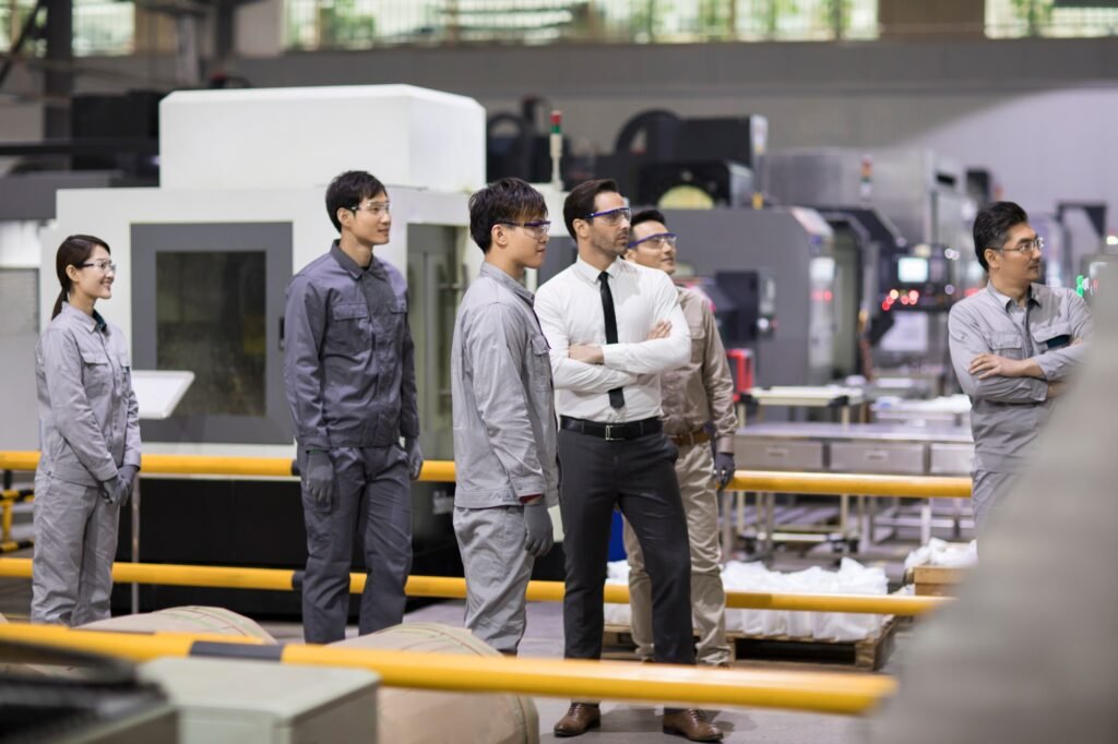 Confident businessman and engineering team in the factory